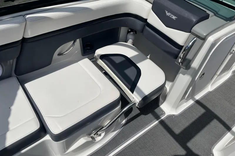 Slide: The Image of 2015 Chaparral Vortex 223 VRX boat interior with white and gray seating. - 14