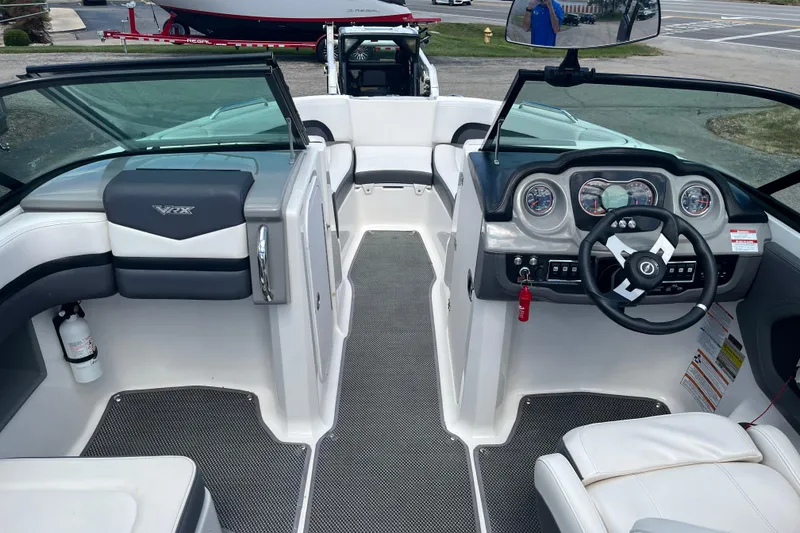 Slide: The Image of 2015 Chaparral Vortex 223 VRX boat interior with steering wheel and seating. - 9