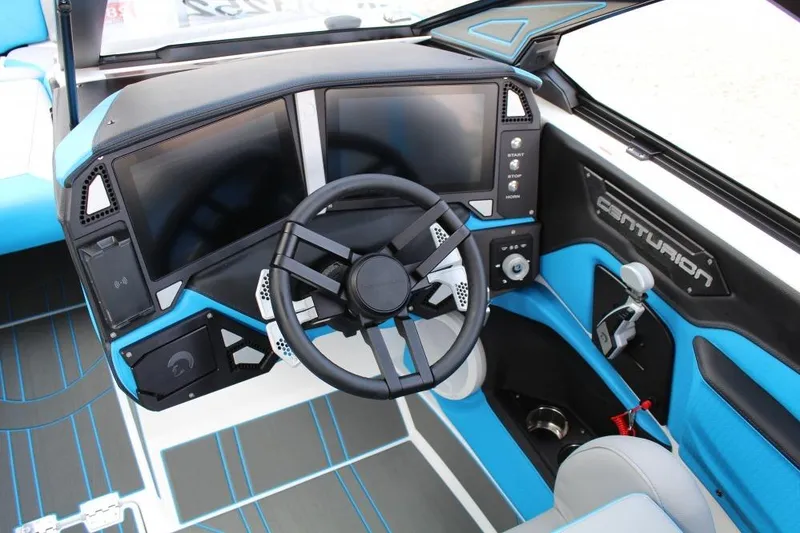 Slide: The Image of 2026 Centurion Ri 230 boat dashboard with modern steering and dual screens. - 12