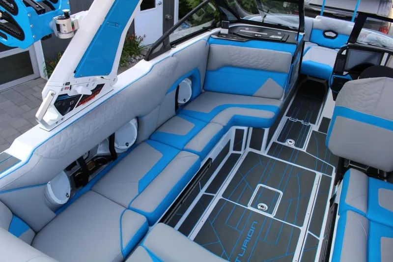 Slide: The Image of 2026 Centurion Ri 230 boat interior with blue and gray seating and modern design. - 5