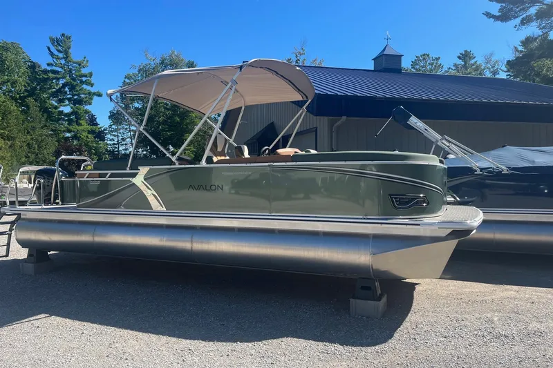 The Image of 2026 Avalon 23 LSZ Quad Lounger pontoon boat with canopy, parked outdoors. - 1