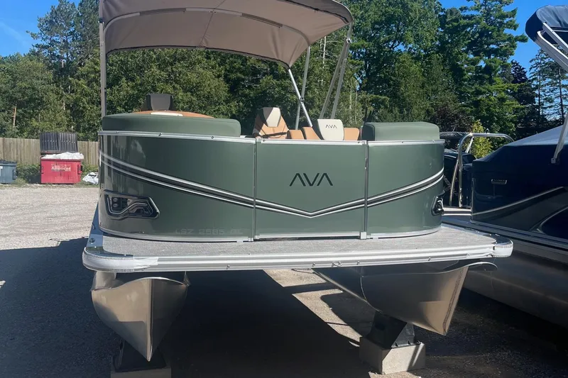 Slide: The Image of 2026 Avalon 23 LSZ Quad Lounger pontoon boat with canopy, parked outdoors. - 10