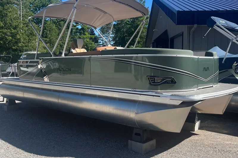 Slide: The Image of 2026 Avalon 23 LSZ Quad Lounger pontoon boat with canopy, displayed outdoors. - 11