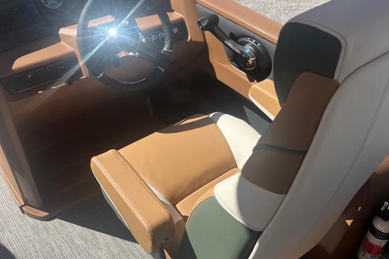 Slide: The Image of 2026 Avalon 23 LSZ Quad Lounger interior with tan and white seating, steering wheel detail. - 4