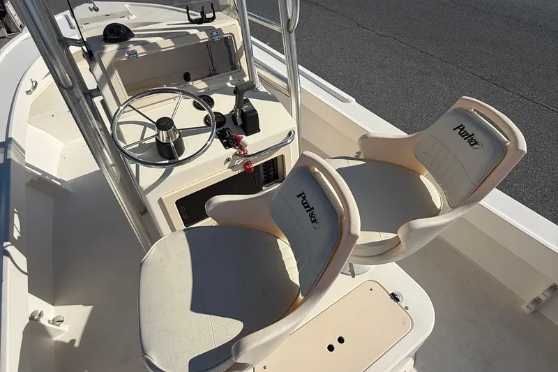 Slide: The Image of 2005 Parker 21 CC boat interior with steering wheel and dual seats. - 10