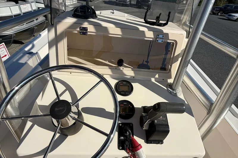 Slide: The Image of 2005 Parker 21 CC boat console with steering wheel and controls. - 11