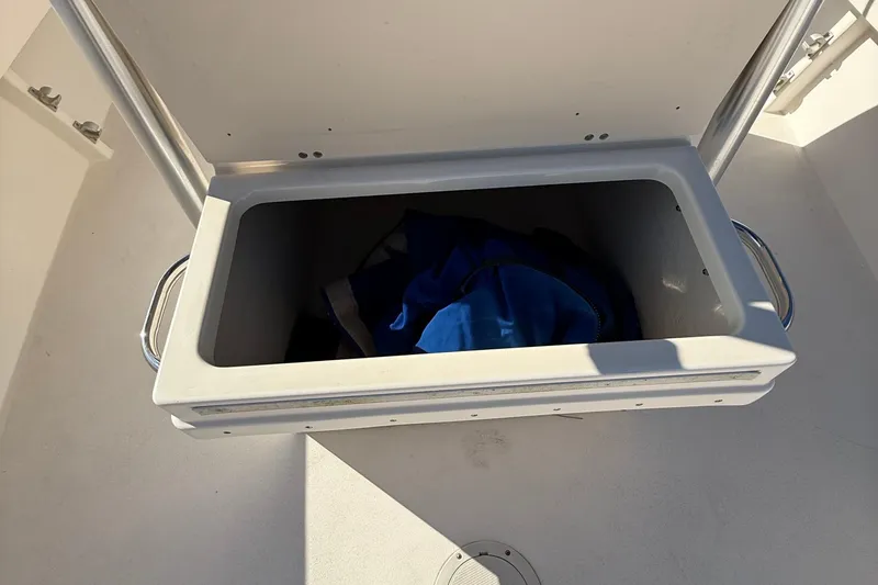 Slide: The Image of Open storage compartment on 2005 Parker 21 CC boat with blue fabric inside. - 15