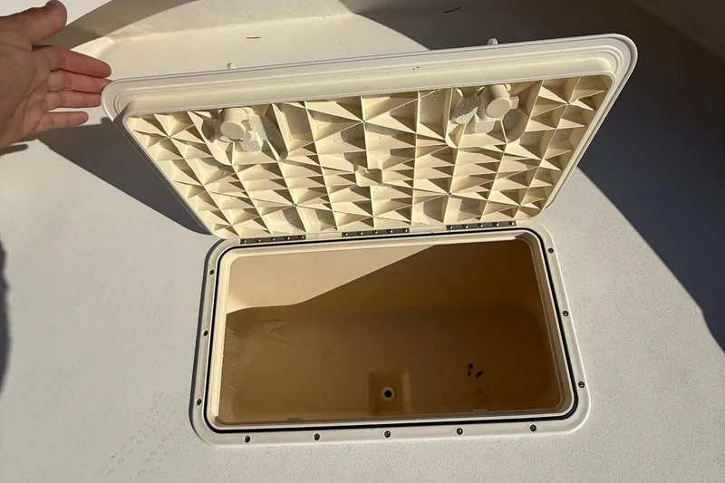Slide: The Image of Open storage compartment on a 2005 Parker 21 CC boat deck. - 16