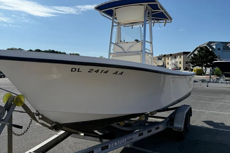 Slide: The Image of 2005 Parker 21 CC boat on trailer in parking lot under clear sky. - 4