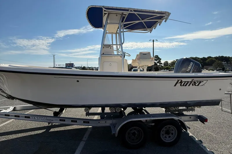 Slide: The Image of 2005 Parker 21 CC boat on trailer, featuring Yamaha engine, under clear blue sky. - 5