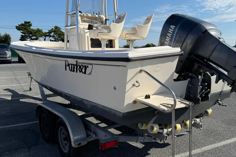 Slide: The Image of 2005 Parker 21 CC boat on trailer with Yamaha outboard motor in parking lot. - 6