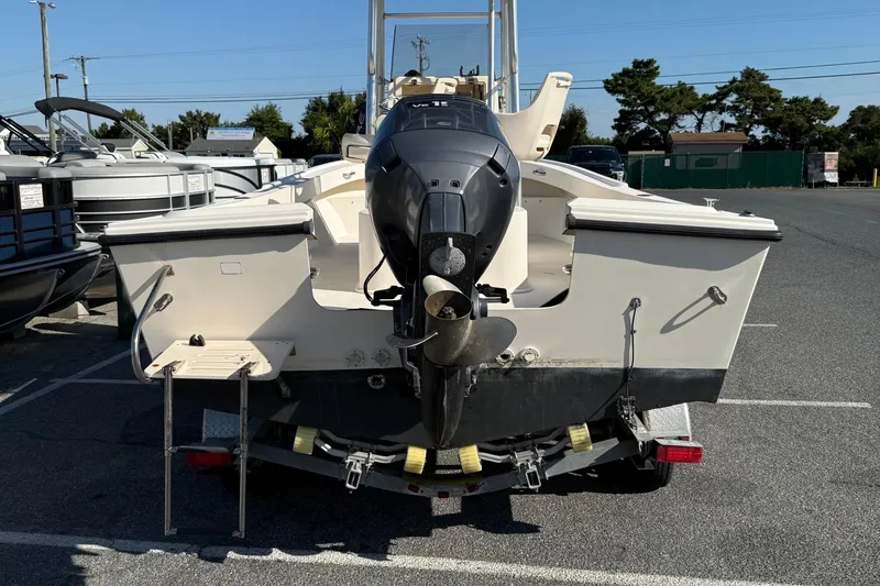 Slide: The Image of 2005 Parker 21 CC boat with outboard motor on trailer in parking lot. - 7