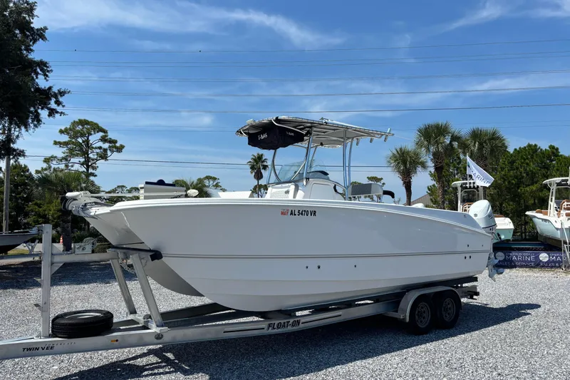 Slide: The Image of 2022 Twin Vee 240 GFX CC boat on trailer, displayed outdoors under clear sky. - 0