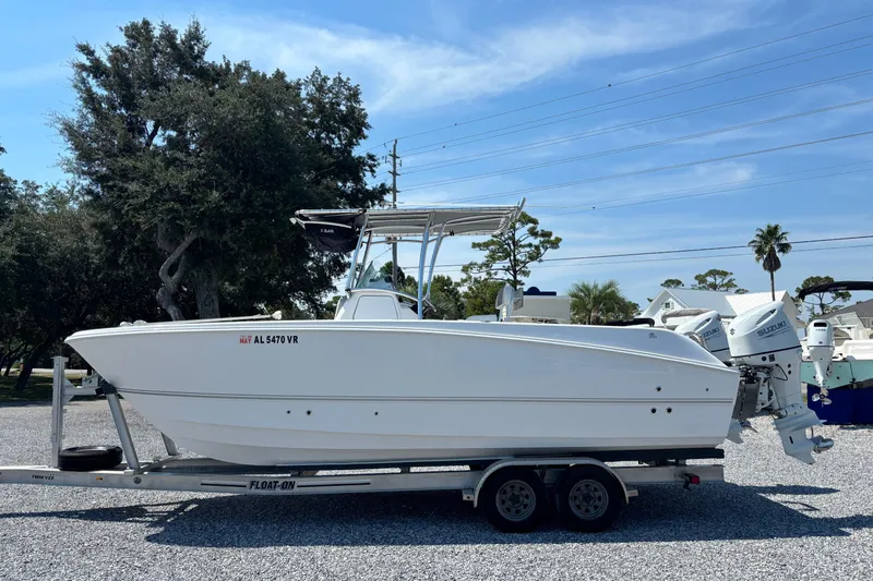 Slide: The Image of 2022 Twin Vee 240 GFX CC boat on trailer, parked outdoors under clear sky. - 1