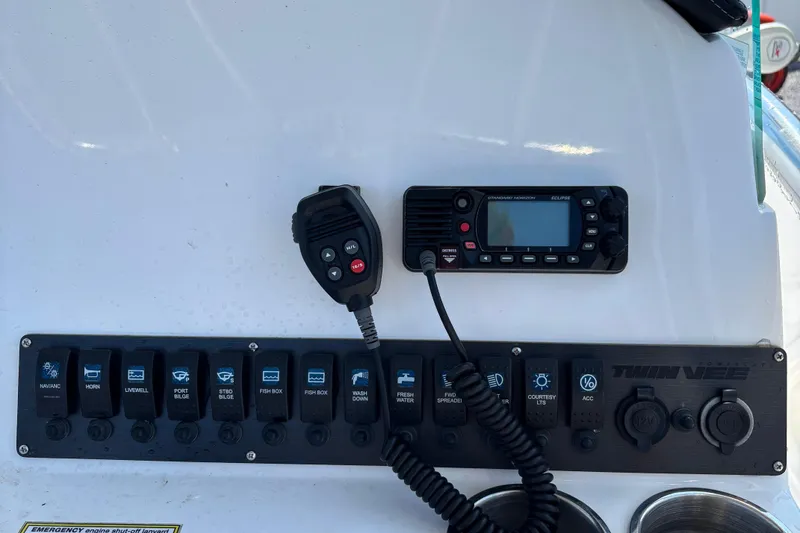 Slide: The Image of Control panel of 2022 Twin Vee 240 GFX CC boat with radio and switches. - 19