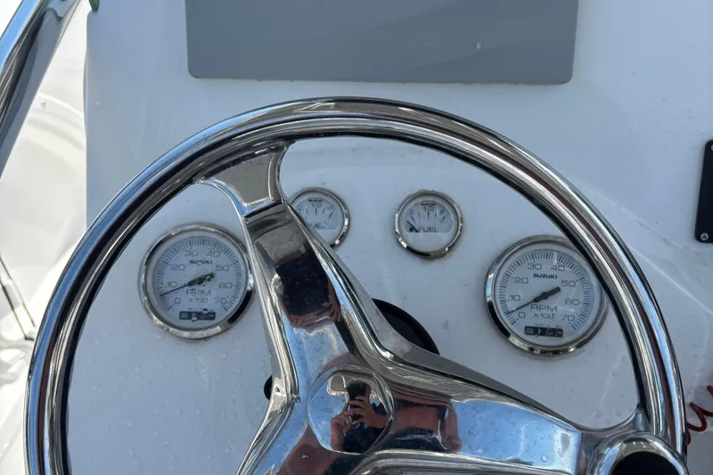 Slide: The Image of Steering wheel and gauges of 2022 Twin Vee 240 GFX CC boat dashboard. - 20