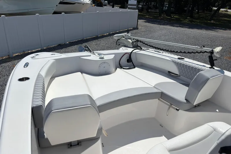 Slide: The Image of 2022 Twin Vee 240 GFX CC boat interior with seating and fishing equipment. - 22