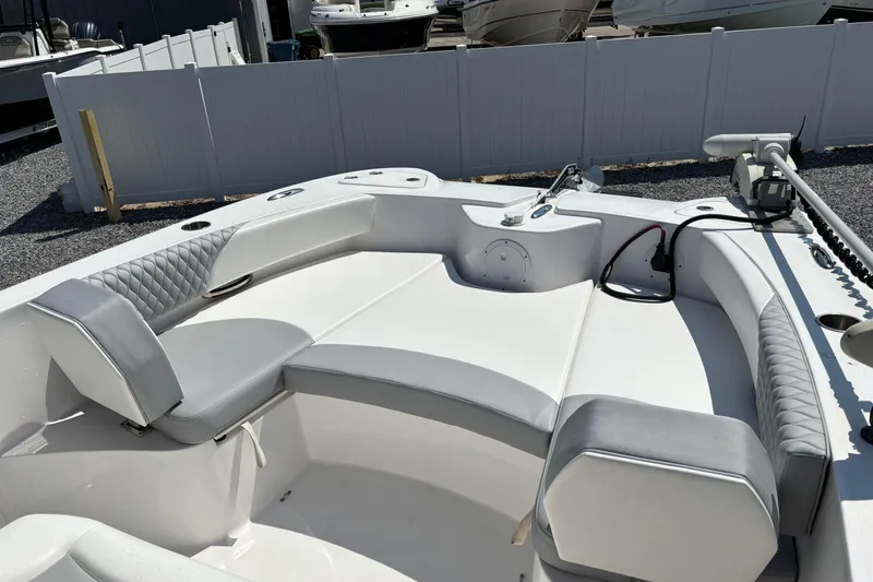 Slide: The Image of 2022 Twin Vee 240 GFX CC boat interior with cushioned seating and modern design. - 23