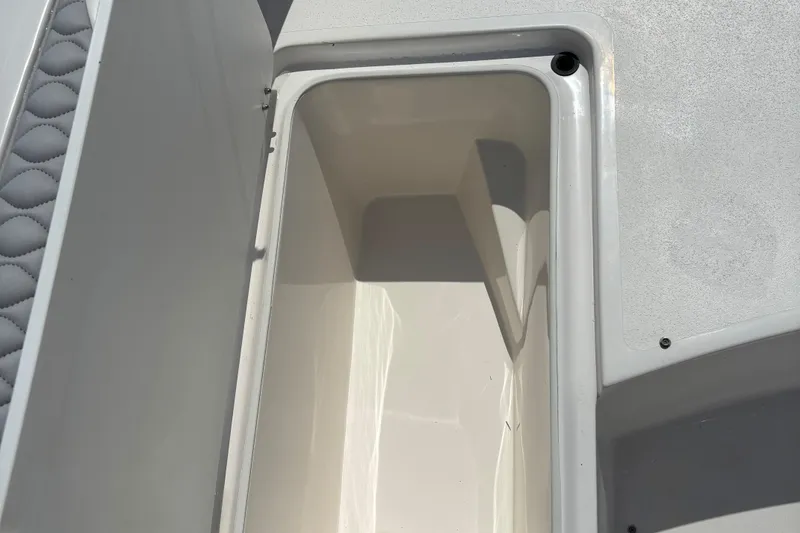 Slide: The Image of Storage compartment on 2022 Twin Vee 240 GFX CC boat, open lid, white interior. - 25