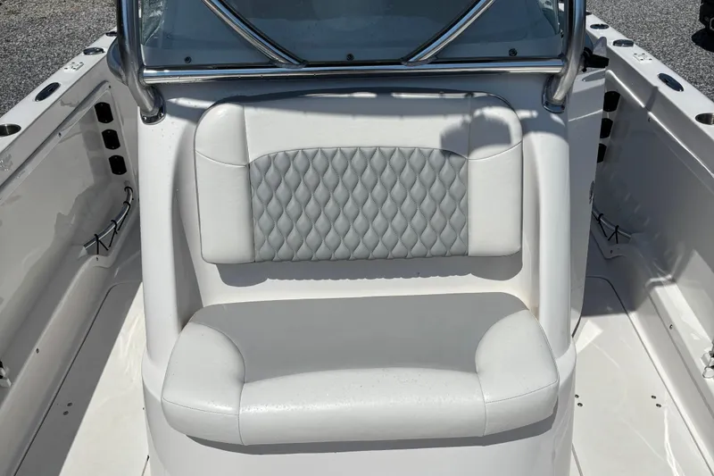 Slide: The Image of 2022 Twin Vee 240 GFX CC boat interior with cushioned seating and diamond-patterned backrest. - 28