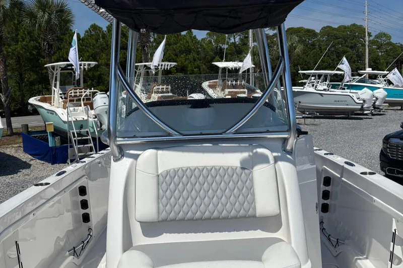 Slide: The Image of 2022 Twin Vee 240 GFX CC boat interior with cushioned seating and sleek design. - 29