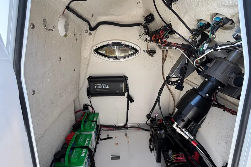 Slide: The Image of Interior of 2022 Twin Vee 240 GFX CC boat showing electrical components and wiring. - 30