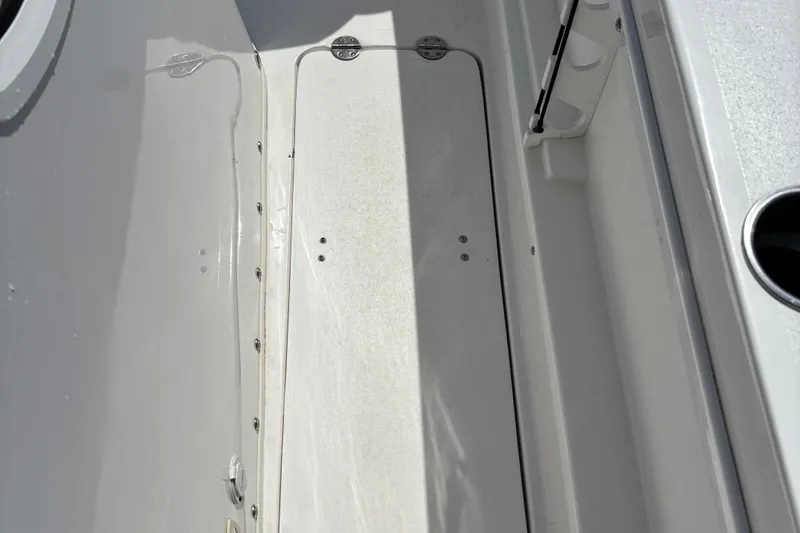 Slide: The Image of 2022 Twin Vee 240 GFX CC boat deck with storage compartment and cup holder. - 32
