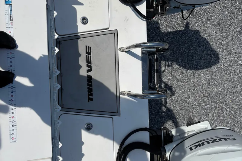 Slide: The Image of 2022 Twin Vee 240 GFX CC boat deck with Suzuki outboard motor and measuring ruler. - 36