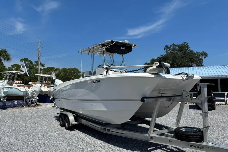 Slide: The Image of 2022 Twin Vee 240 GFX CC boat on trailer under clear blue sky. - 6