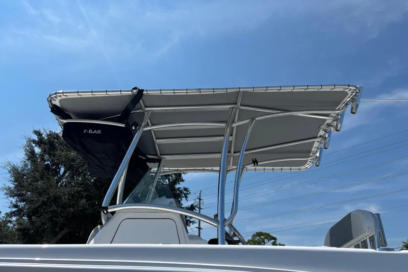 Slide: The Image of 2022 Twin Vee 240 GFX CC boat with T-top against blue sky. - 8