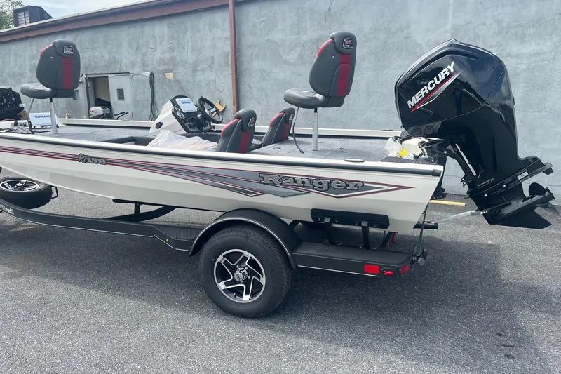 The Image of 2025 Ranger RT178 boat with Mercury engine on trailer, parked outdoors. - 0