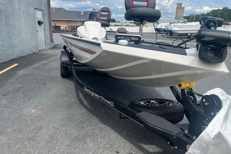 Slide: The Image of 2025 Ranger RT178 boat on trailer, parked outdoors, showcasing sleek design and modern features. - 2