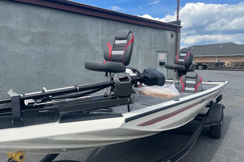 Slide: The Image of 2025 Ranger RT178 boat with modern seating and trolling motor, parked outdoors. - 3