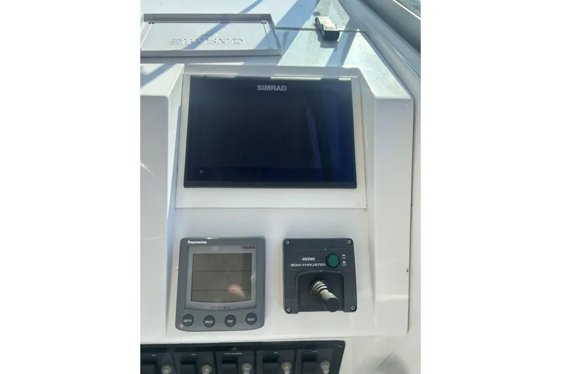Slide: The Image of 1998 Mainship Pilot 30 dashboard with Simrad display and Raymarine TriData. - 11