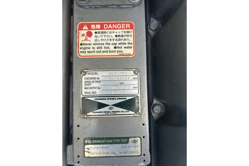 Slide: The Image of Yanmar diesel engine plate with safety warning on Mainship Pilot 30, 1998 model. - 12