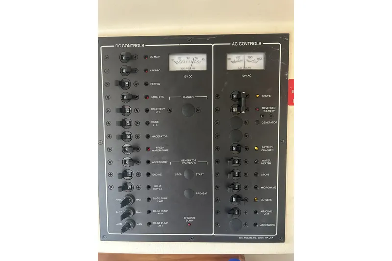 Slide: The Image of Electrical control panel of a 1998 Mainship Pilot 30 boat, featuring DC and AC controls. - 15