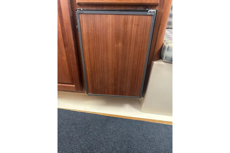 Slide: The Image of Wooden cabinet door on 1998 Mainship Pilot 30 boat interior. - 18