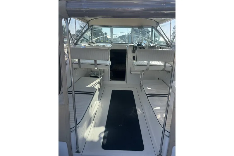 Slide: The Image of 1998 Mainship Pilot 30 interior with seating and helm, showcasing spacious design. - 7