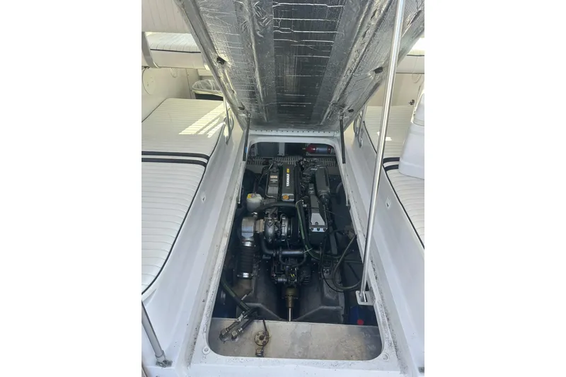 Slide: The Image of 1998 Mainship Pilot 30 engine compartment with open hatch, showcasing the boat's interior mechanics. - 8