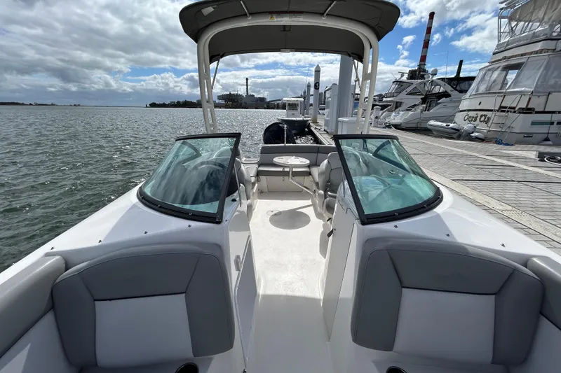 Slide: The Image of 2022 NauticStar 243 DC boat docked, featuring spacious seating and sleek design. - 16