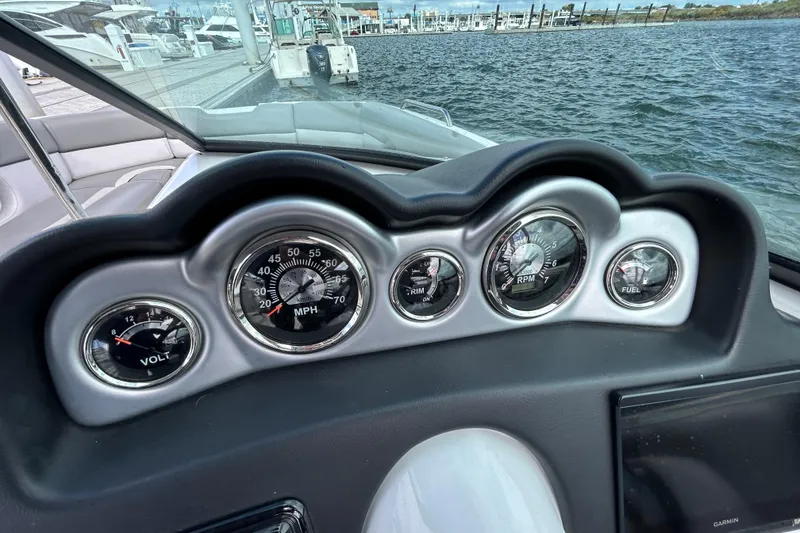 Slide: The Image of Dashboard of 2022 NauticStar 243 DC boat with gauges for speed, RPM, voltage, and fuel. - 17