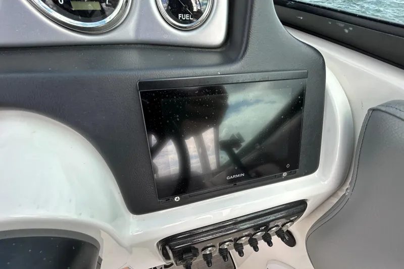 Slide: The Image of Dashboard of 2022 NauticStar 243 DC with Garmin display and fuel gauge. - 8
