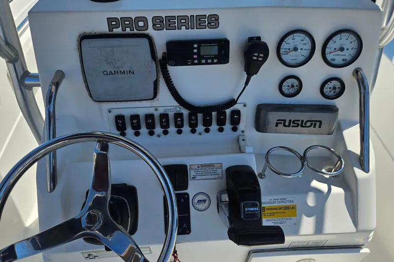 Slide: The Image of 2012 Sea Fox 226CC boat dashboard with Garmin, Fusion audio, and Yamaha controls. - 3