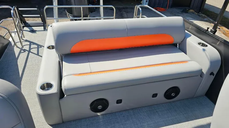 Slide: The Image of 2025 Bentley Pontoons Legacy 243 Swingback on trailer, featuring sleek black and orange design. - 15