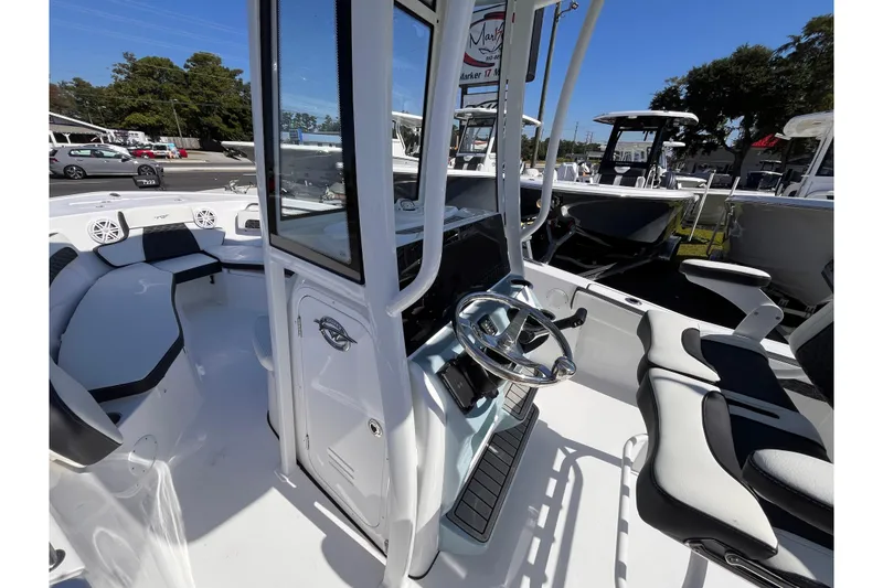 Slide: The Image of 2026 Tidewater 220 LXF boat interior with modern helm and seating. - 13