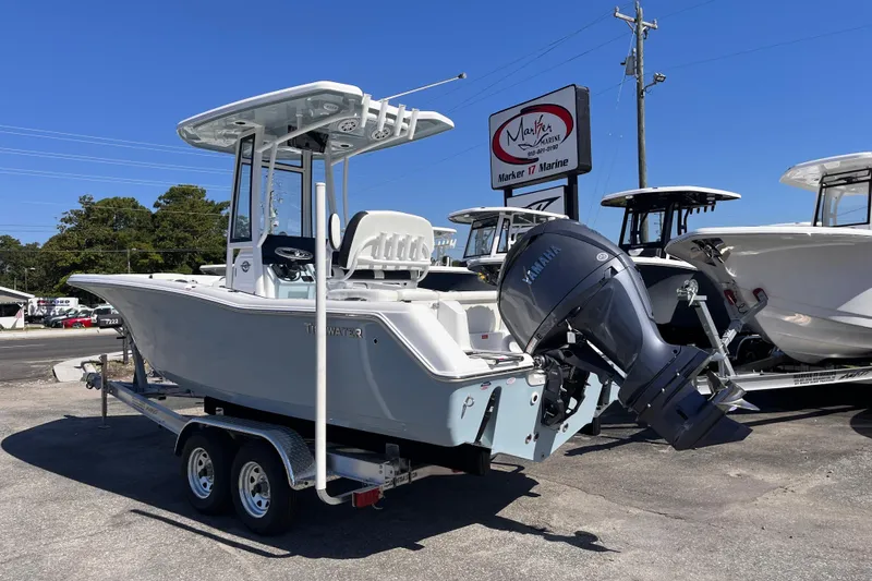 Slide: The Image of 2026 Tidewater 220 LXF boat on trailer at Marker 17 Marine dealership. - 2