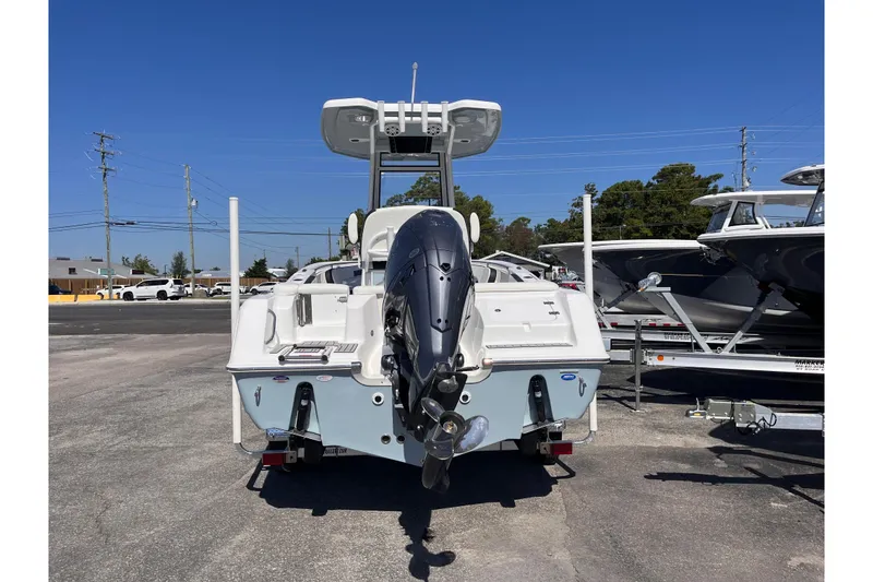 Slide: The Image of 2026 Tidewater 220 LXF boat with outboard motor in a marina setting. - 3