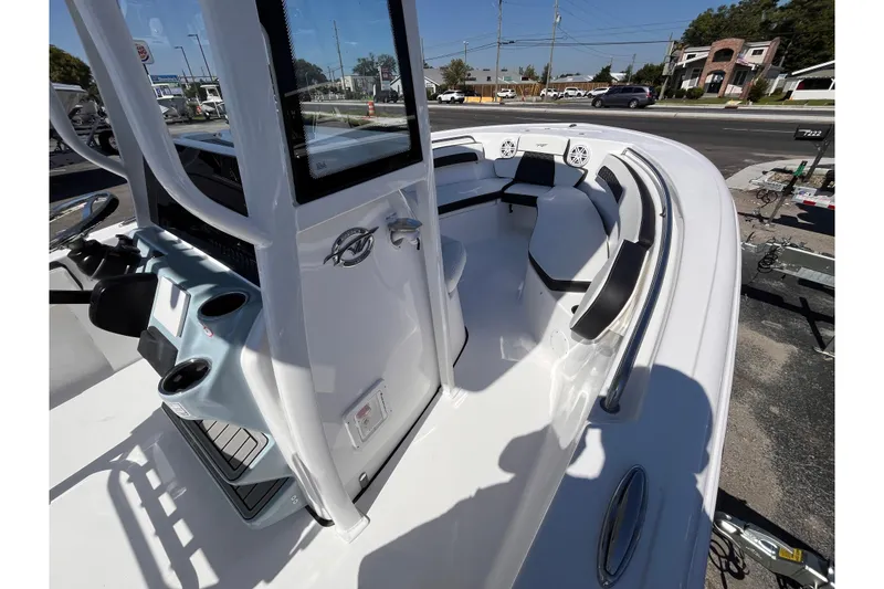 Slide: The Image of 2026 Tidewater 220 LXF boat interior with seating and console, parked on a trailer. - 9