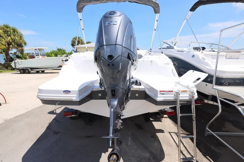 Slide: The Image of 2026 Hurricane SunDeck Sport 205 OB boat interior with spacious seating and modern steering console. - 13