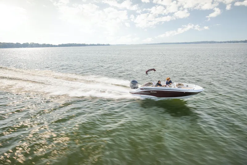Slide: The Image of 2026 Hurricane SunDeck Sport 205 OB boat with powerful outboard motor, parked outdoors. - 14